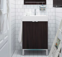 Close-up of a dark brown wash-stand in a bathroom with white tiles.