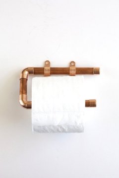 DIY wood and copper toilet paper holder hung on white wall