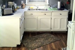 Kitchen cabinets painted white with beadboard