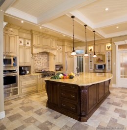 Luxury Kitchen Design with High Coffered Ceilings, Antique White Cabinets, and a Dark Wood Island