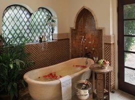 Moroccan patterns meet Spanish Colonial style in this lavish bathroom [Design: PavoReal Interiors]