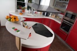 Round red modern kitchen with white counter tops