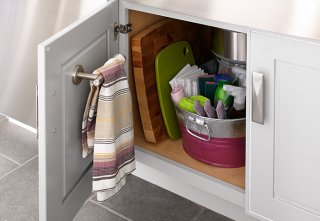 towel rod mounted inside of a lower kitchen cabinet door